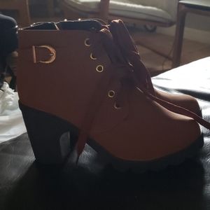 High heeled tan laced shoes with a zipper